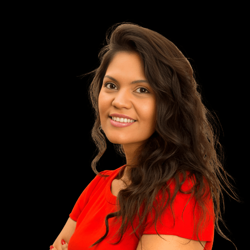 Confident young woman with long wavy hair wearing a red top, smiling warmly against a black background