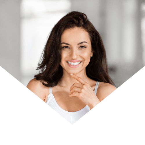Smiling woman with glowing skin after professional facial treatment at Body and Skin Clinic, showcasing natural beauty and skin confidence