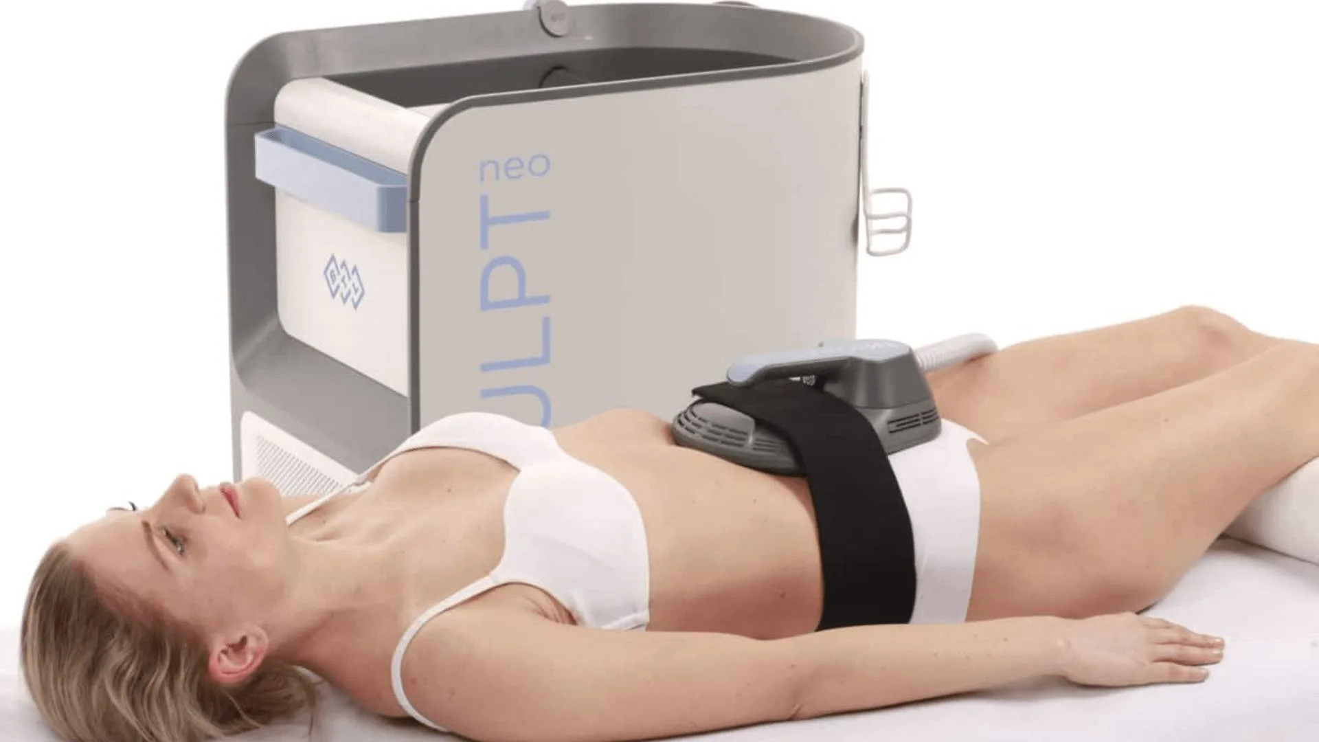Woman undergoing Emsculpt Neo body contouring treatment with device applied to abdomen for fat reduction and muscle toning.